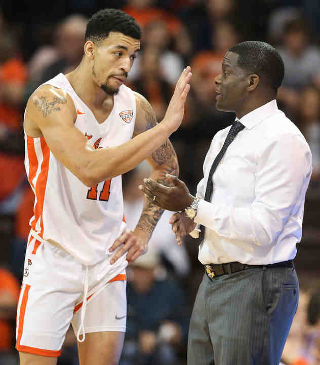 Bowling Green guard Antwon Lillard (11) and head coach Michael Huger talk on the sidelines during a game against Western Carolina at the Stroh Center in Bowling Green. BGSU defeated Western Carolina 73-52.